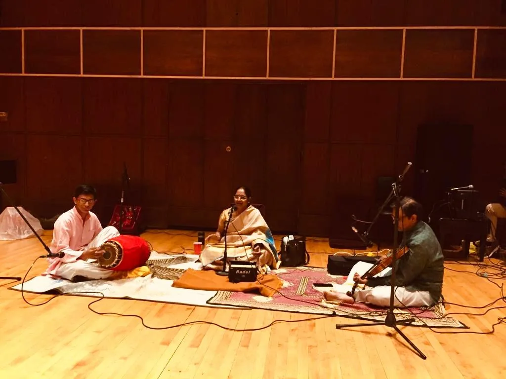 Krishnaveni singing with mridangam and violin accompaniment at Binghamton University.